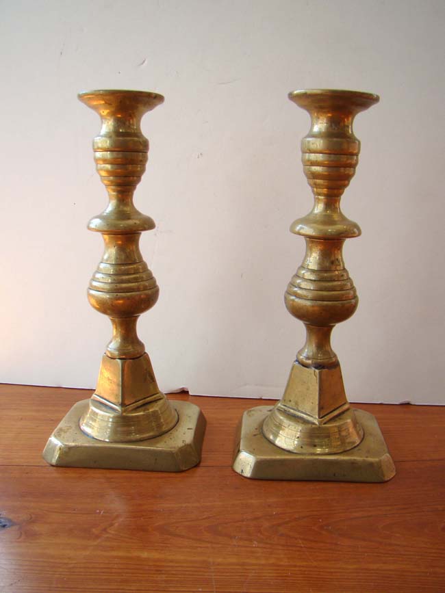 A fine pair of 19th century English brass beehive form candlesticks with unusual shaped stem